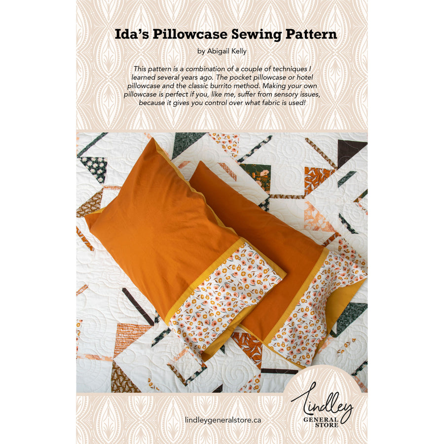Sewing pattern cover for 'Ida's Pillowcase' with orange pillowcases on a quilted background.